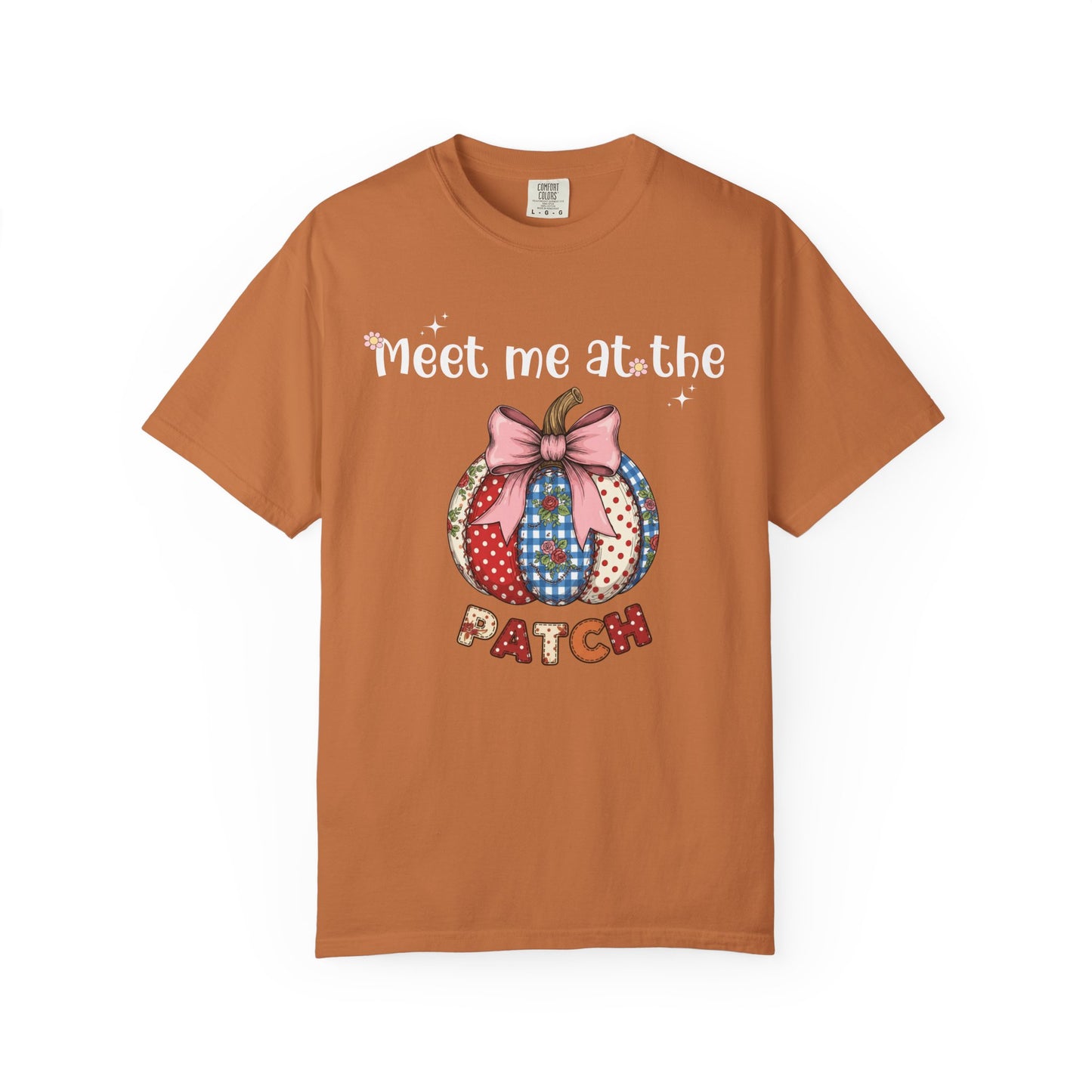 Brown t-shirt with a patchwork pumpkin design and text on a white background