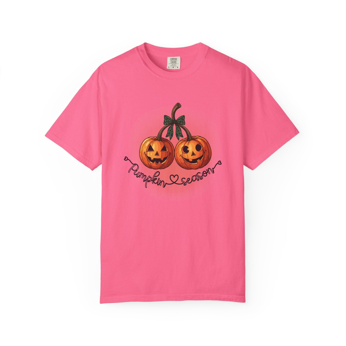 Pink t-shirt with pumpkin design and text on a white background