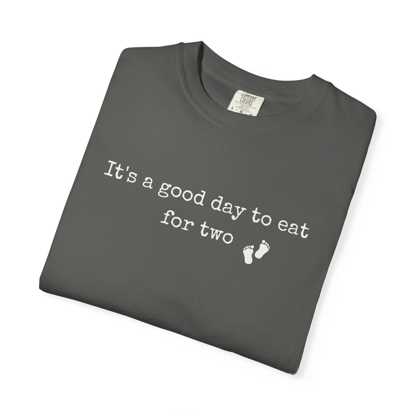 Folded dark gray t-shirt with white text on a white background