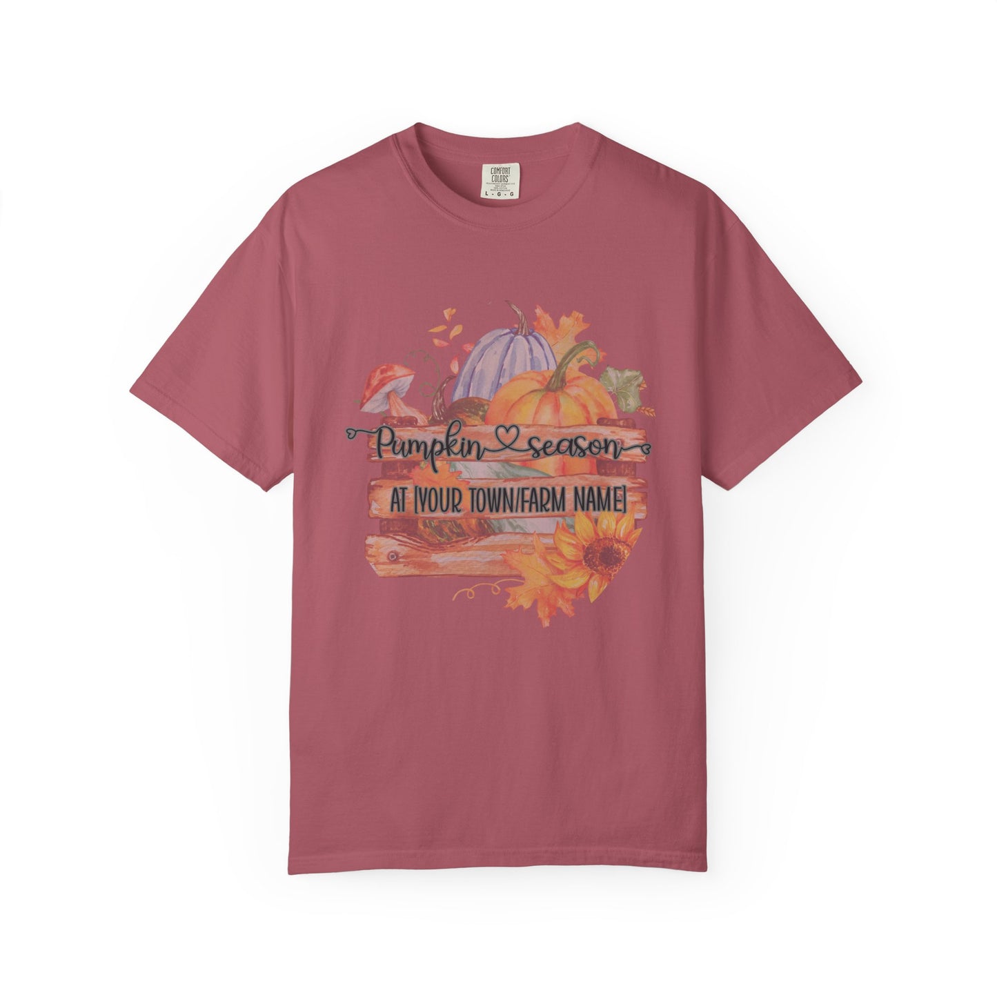 Maroon t-shirt with pumpkin season graphic on a white background