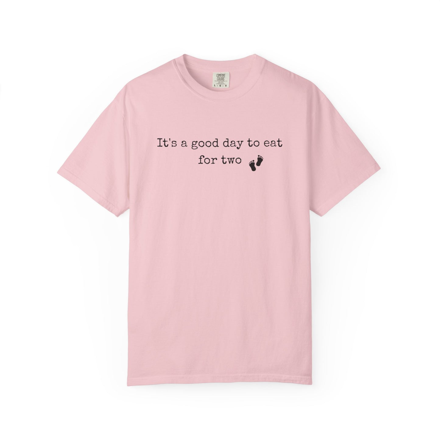 Pink t-shirt with text 'It's a good day to eat for two' on a white background