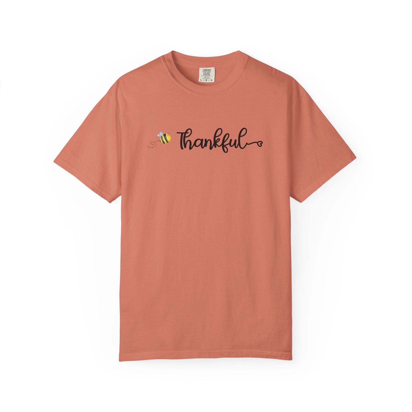 Coral t-shirt with 'Thankful' text and bee graphic on a white background