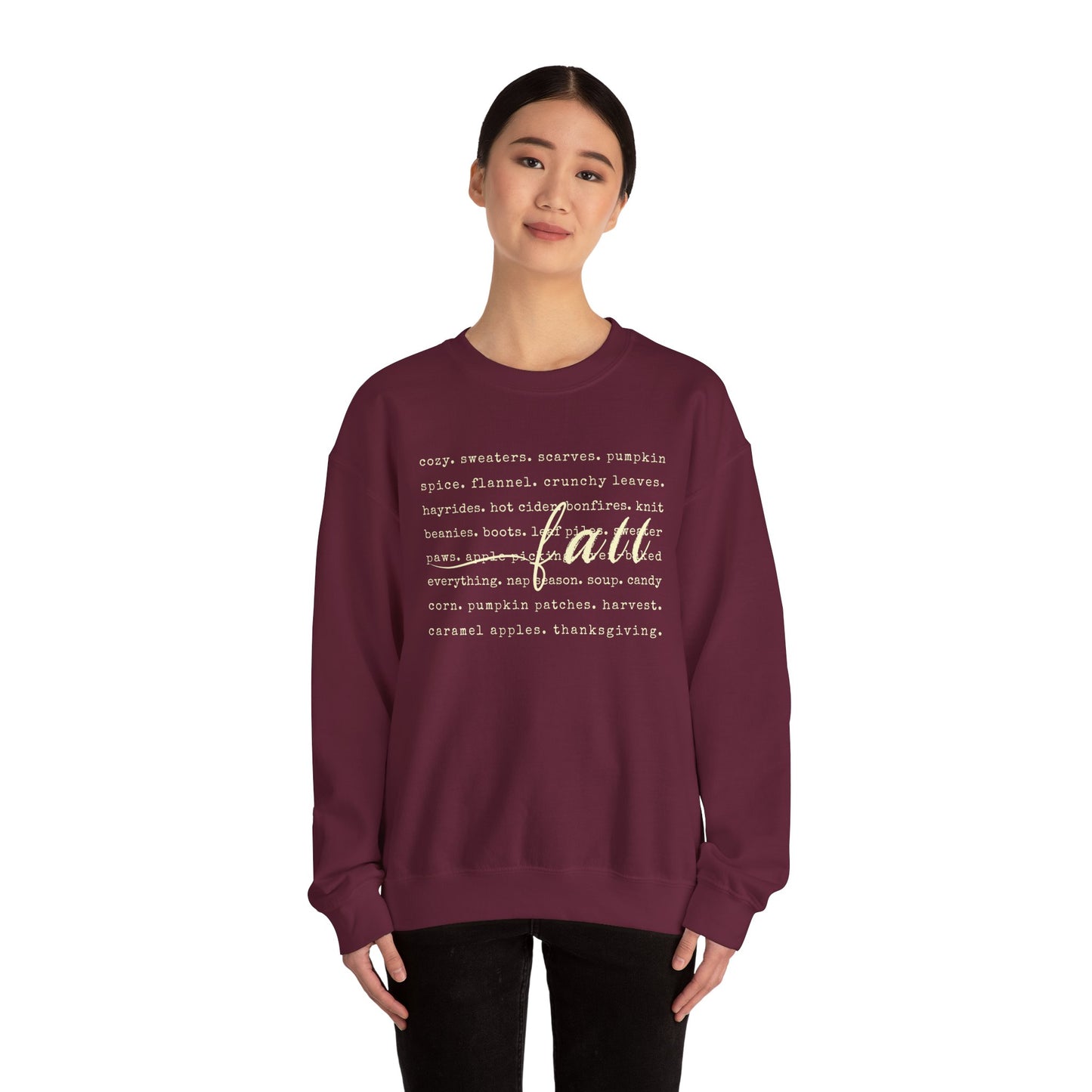 Person wearing a maroon sweatshirt with text design on a white background