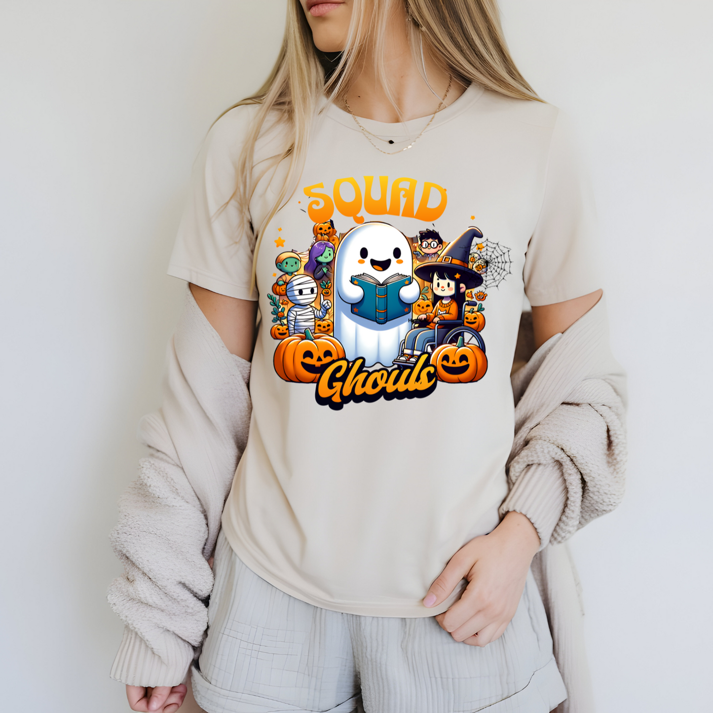 Person wearing a beige t-shirt with a colorful graphic design featuring cartoon characters and text.