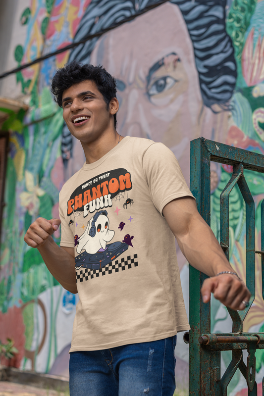 Man wearing a beige t-shirt with graphic design in front of a colorful mural.