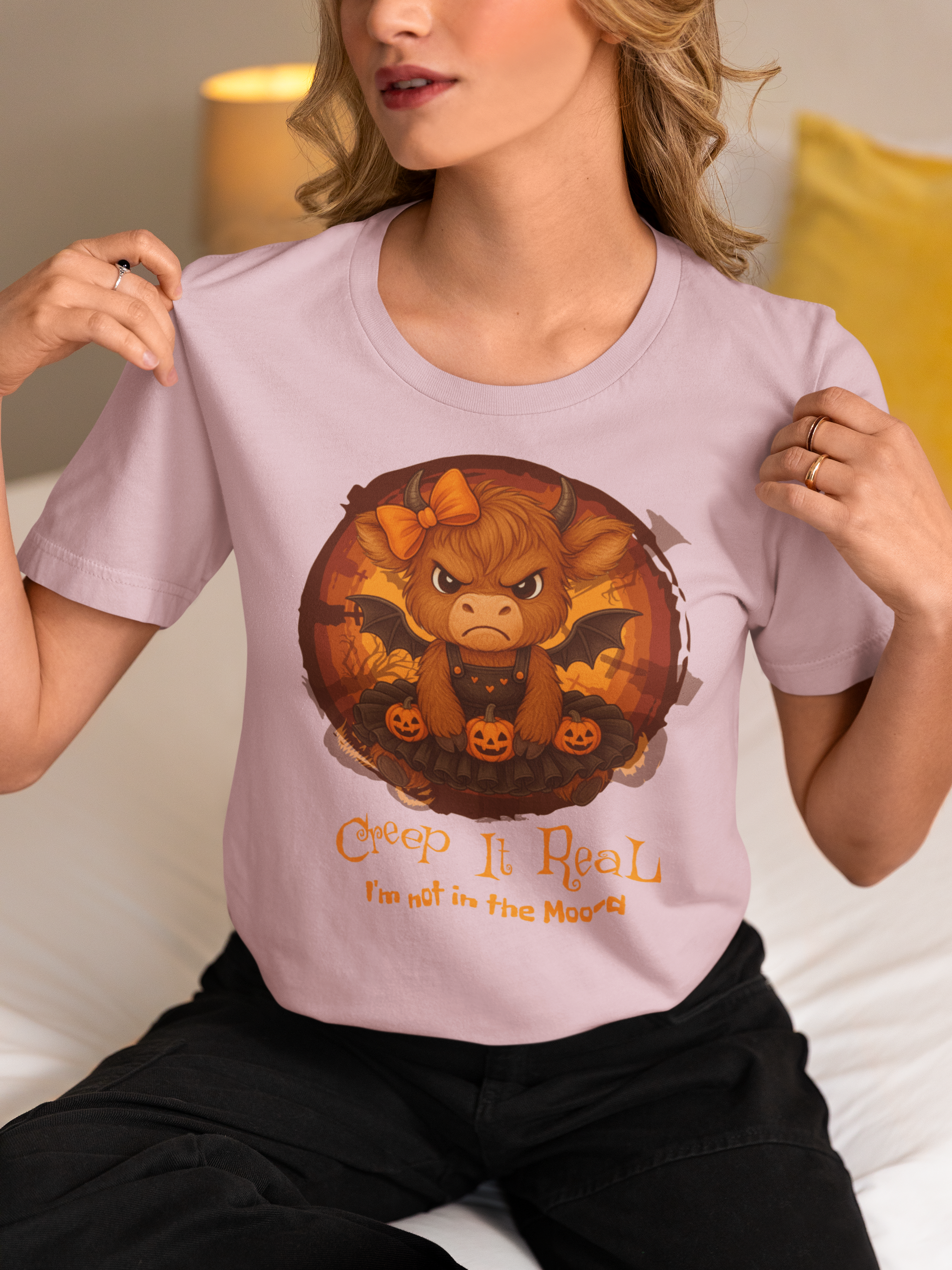 Person wearing a light purple t-shirt with a graphic design of a bull and text.