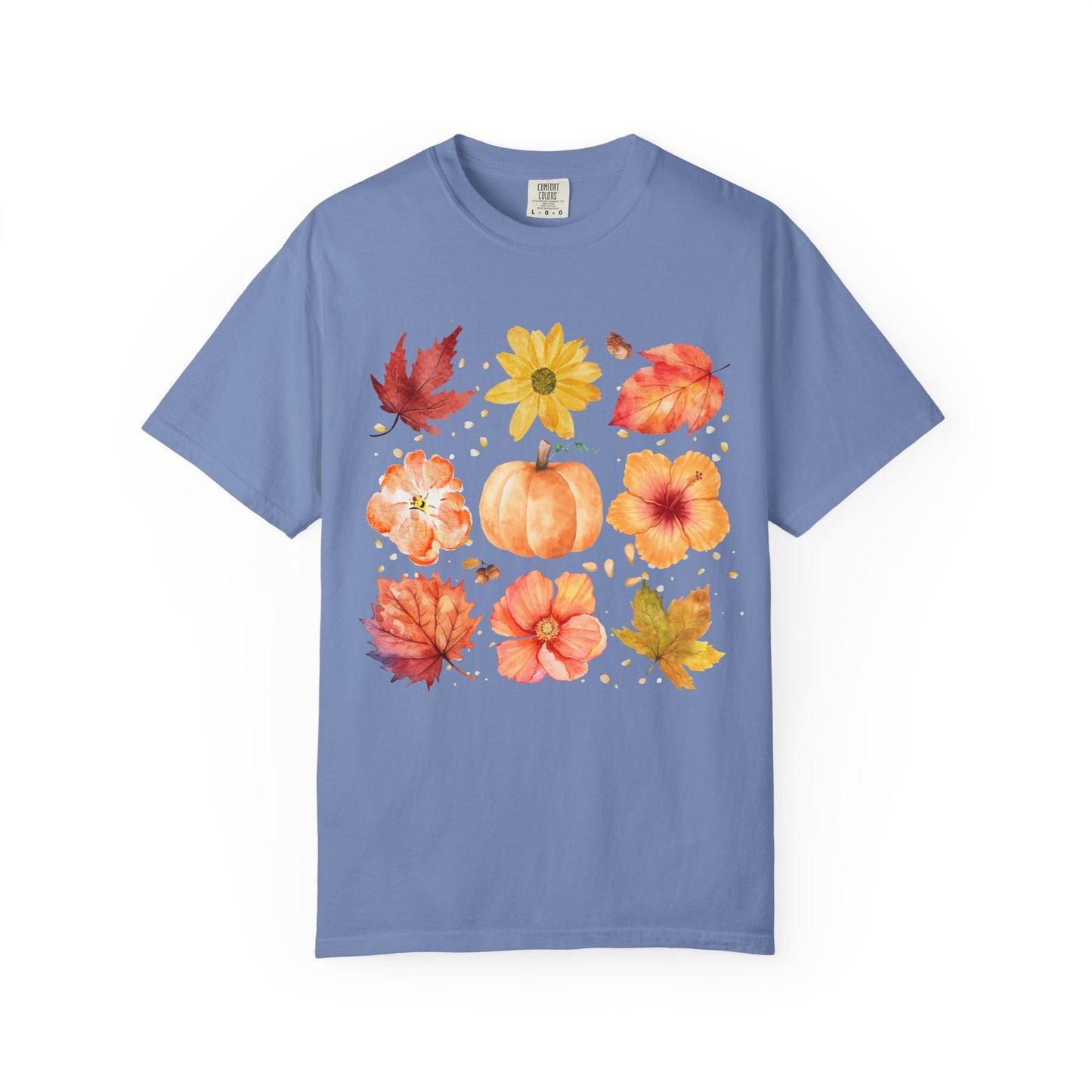 Blue t-shirt with autumn-themed design featuring leaves, flowers, and a pumpkin on a white background.