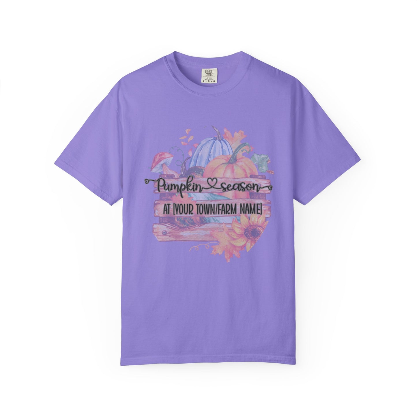 Purple t-shirt with pumpkin season graphic on a white background