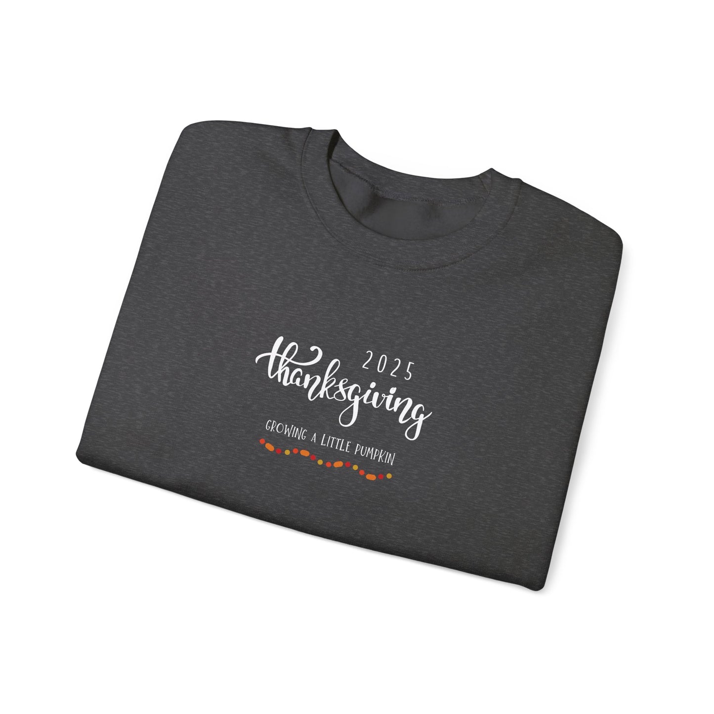Folded dark gray shirt with '2025 Thanksgiving Growing a Little Pumpkin' text on a white background
