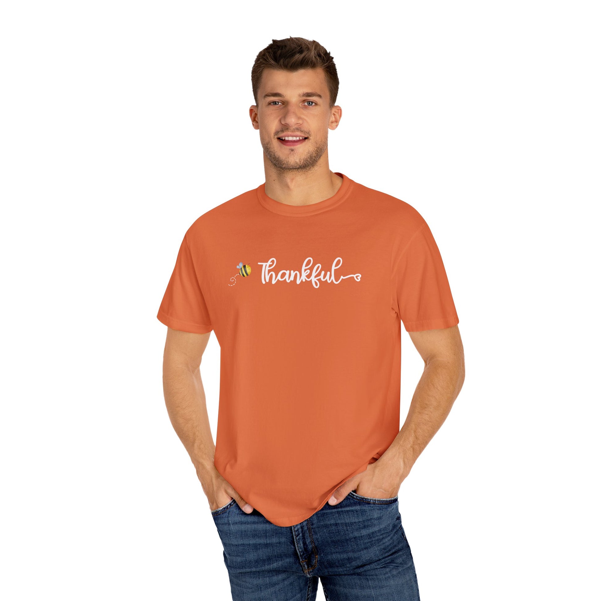 Man wearing an orange t-shirt with 'Thankful' text on a white background