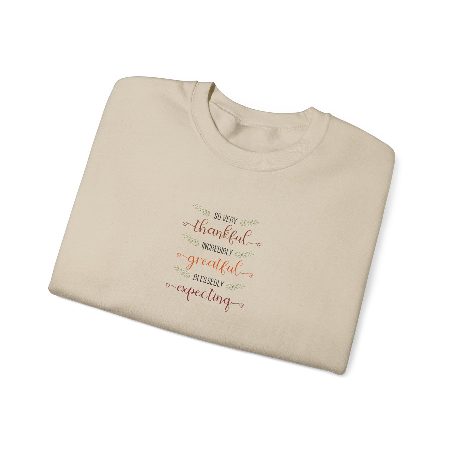 Folded beige sweatshirt with text on a white background