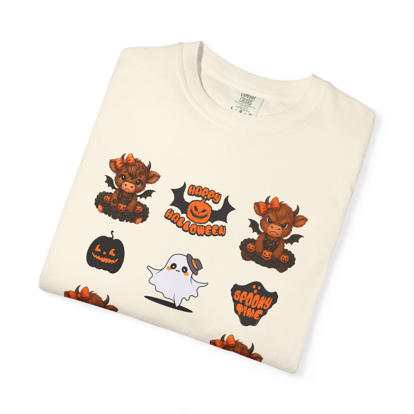 Folded cream-colored t-shirt with Halloween-themed graphics on a white background
