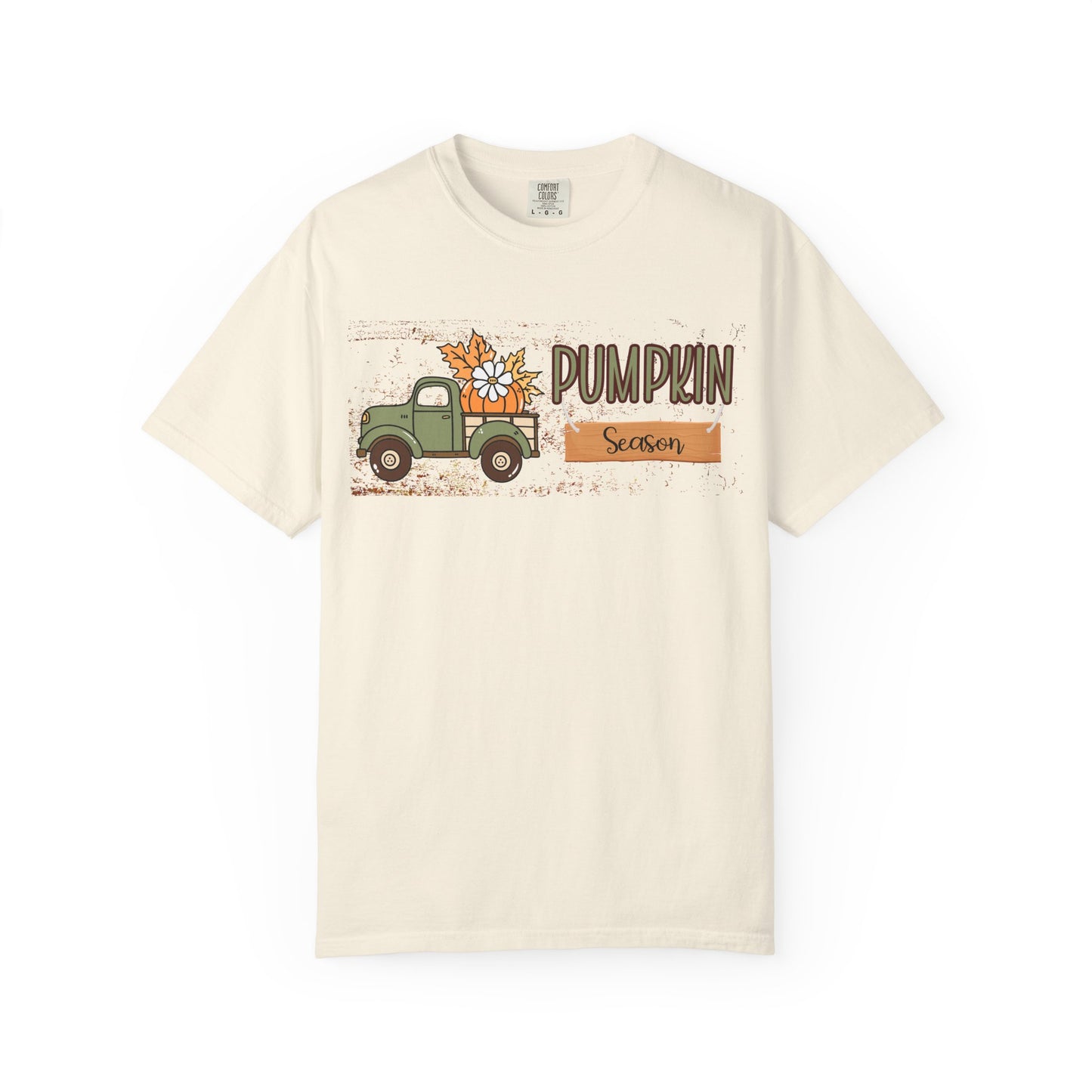 Beige t-shirt with a graphic of a truck and pumpkins labeled 'Pumpkin Season' on a white background