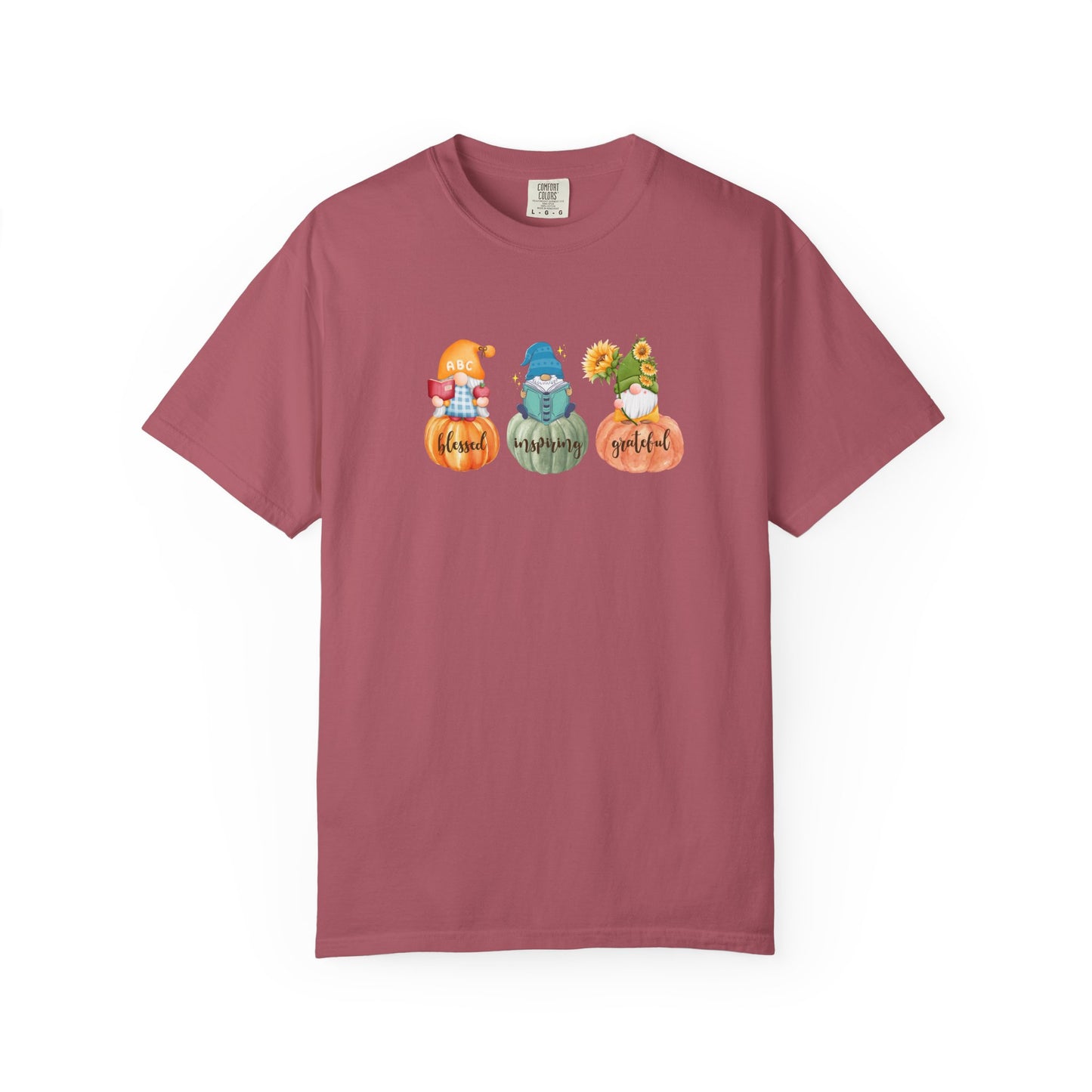 Maroon t-shirt with gnomes and pumpkins design on a white background