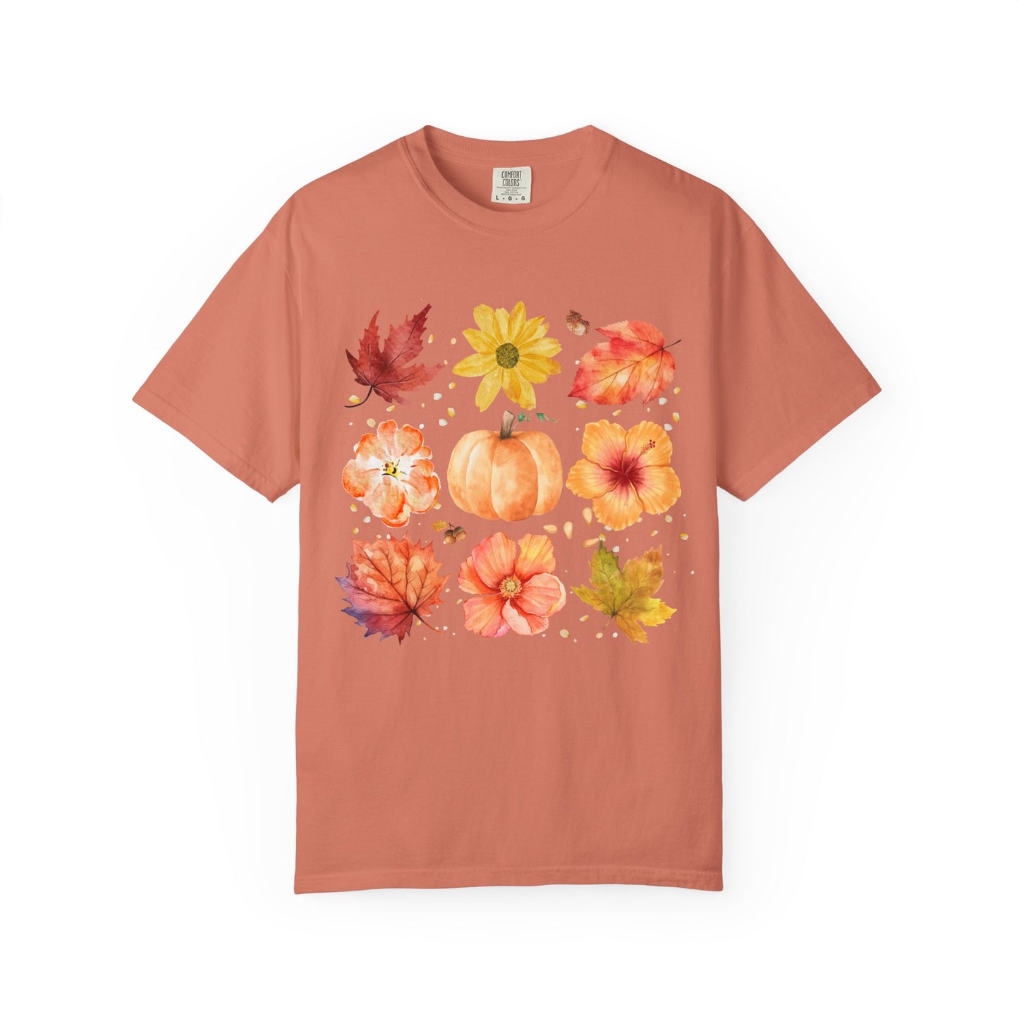 Coral t-shirt with autumn-themed design featuring leaves and pumpkins on a white background