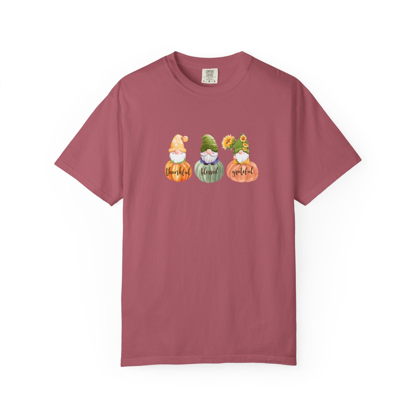 Maroon t-shirt with three cartoon gnomes and pumpkins on a white background