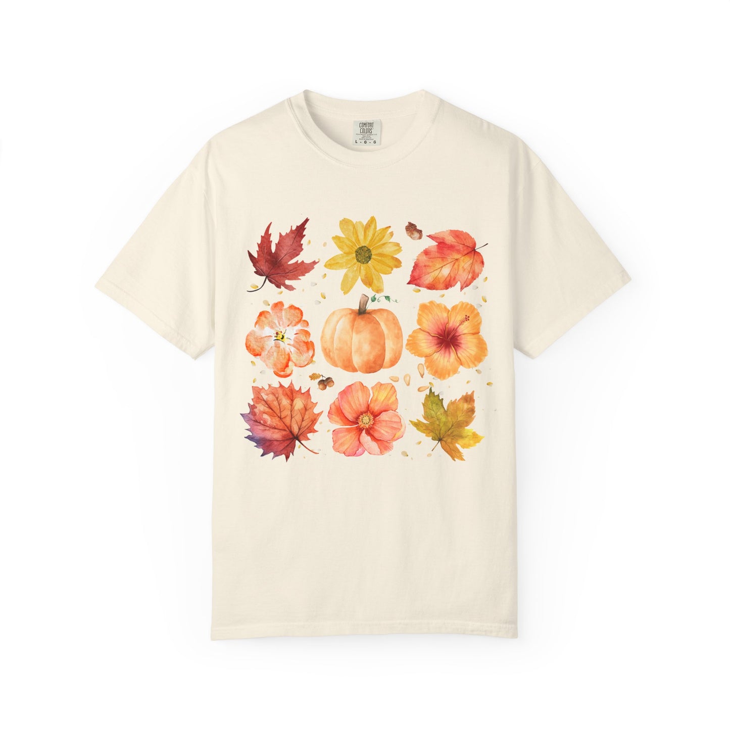 Beige t-shirt with autumn-themed design featuring leaves and pumpkins on a white background