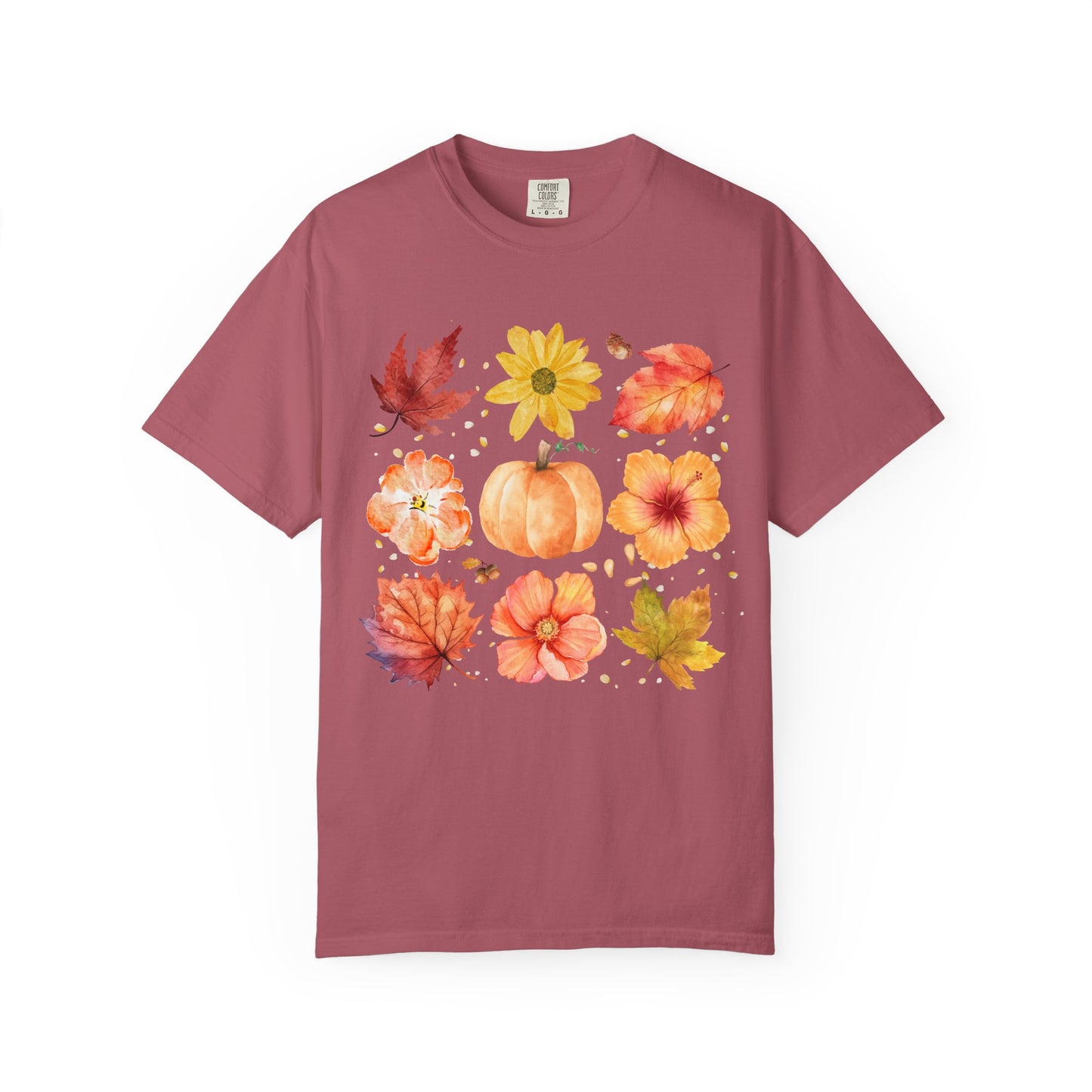 Maroon t-shirt with autumn-themed design featuring pumpkins, leaves, and flowers on a white background.