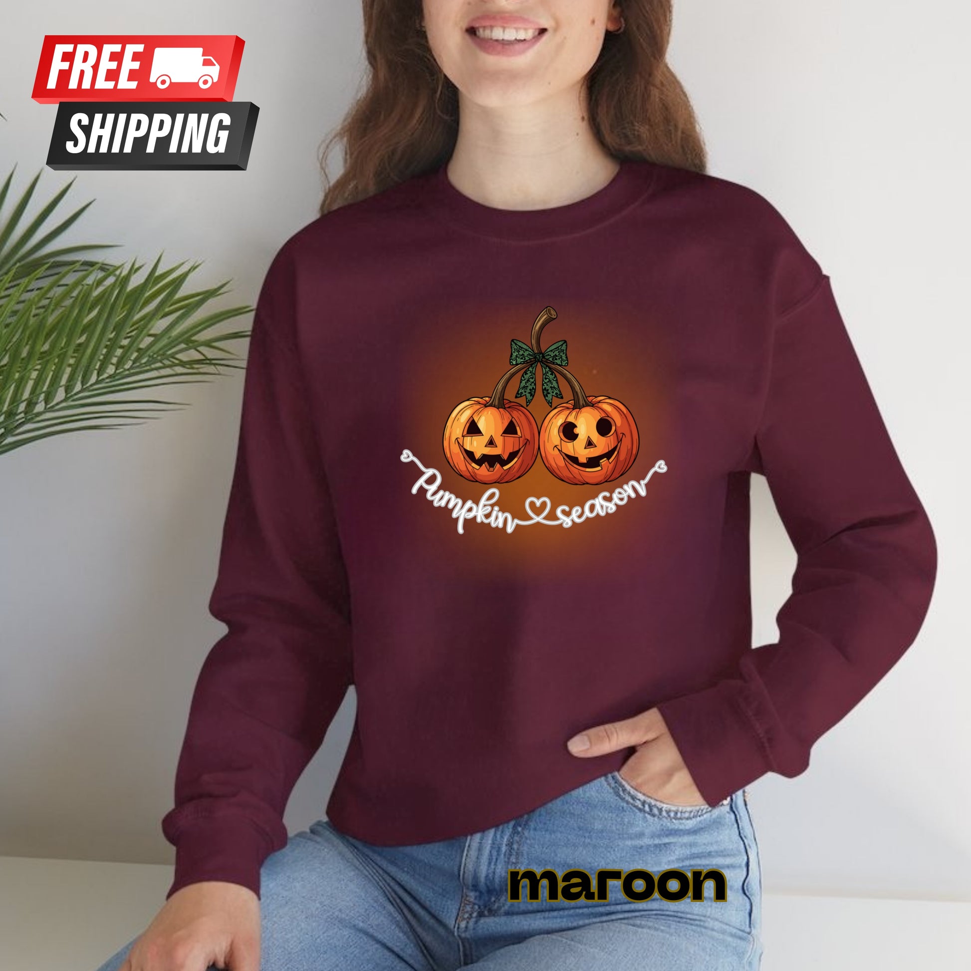 Person wearing a maroon sweatshirt with pumpkin design and 'Pumpkin Season' text, sitting indoors.