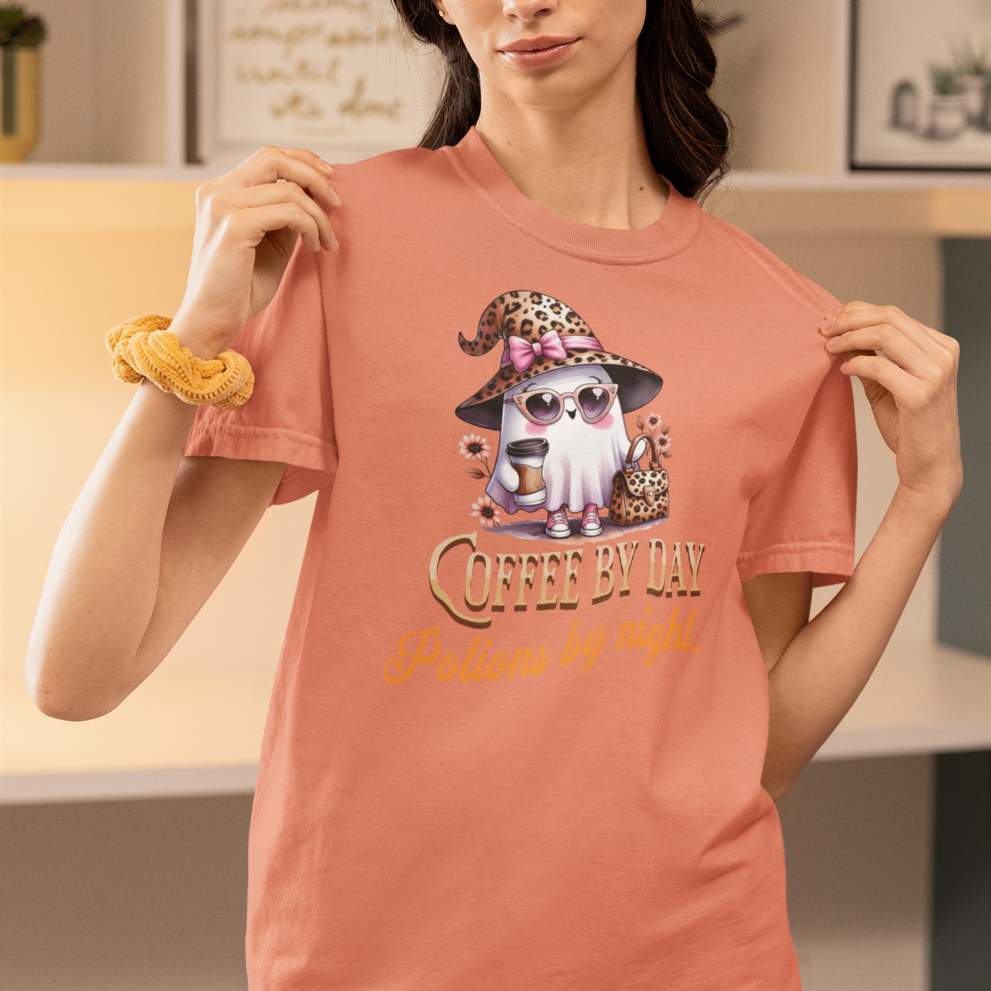 Person wearing a pink t-shirt with a cartoon character and text 'Coffee by day, Netflix by night'.