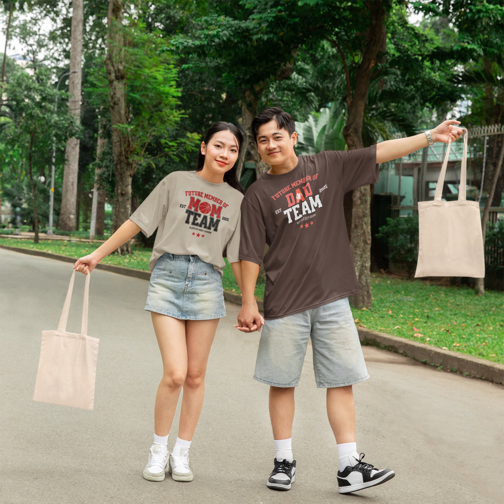 Two people standing outdoors with trees and a building in the background