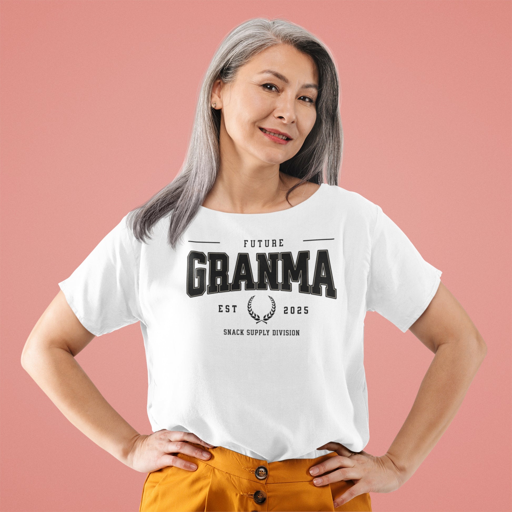 Woman wearing a white t-shirt with 'Future Grandma' text on a pink background