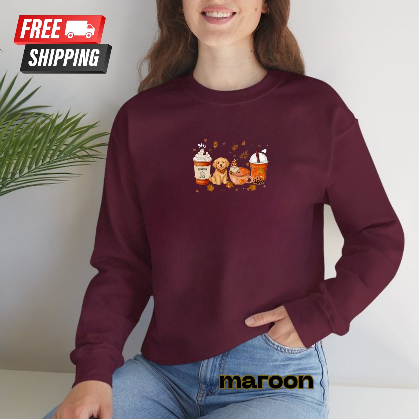 Person wearing a maroon sweatshirt with a graphic design, sitting against a white background.