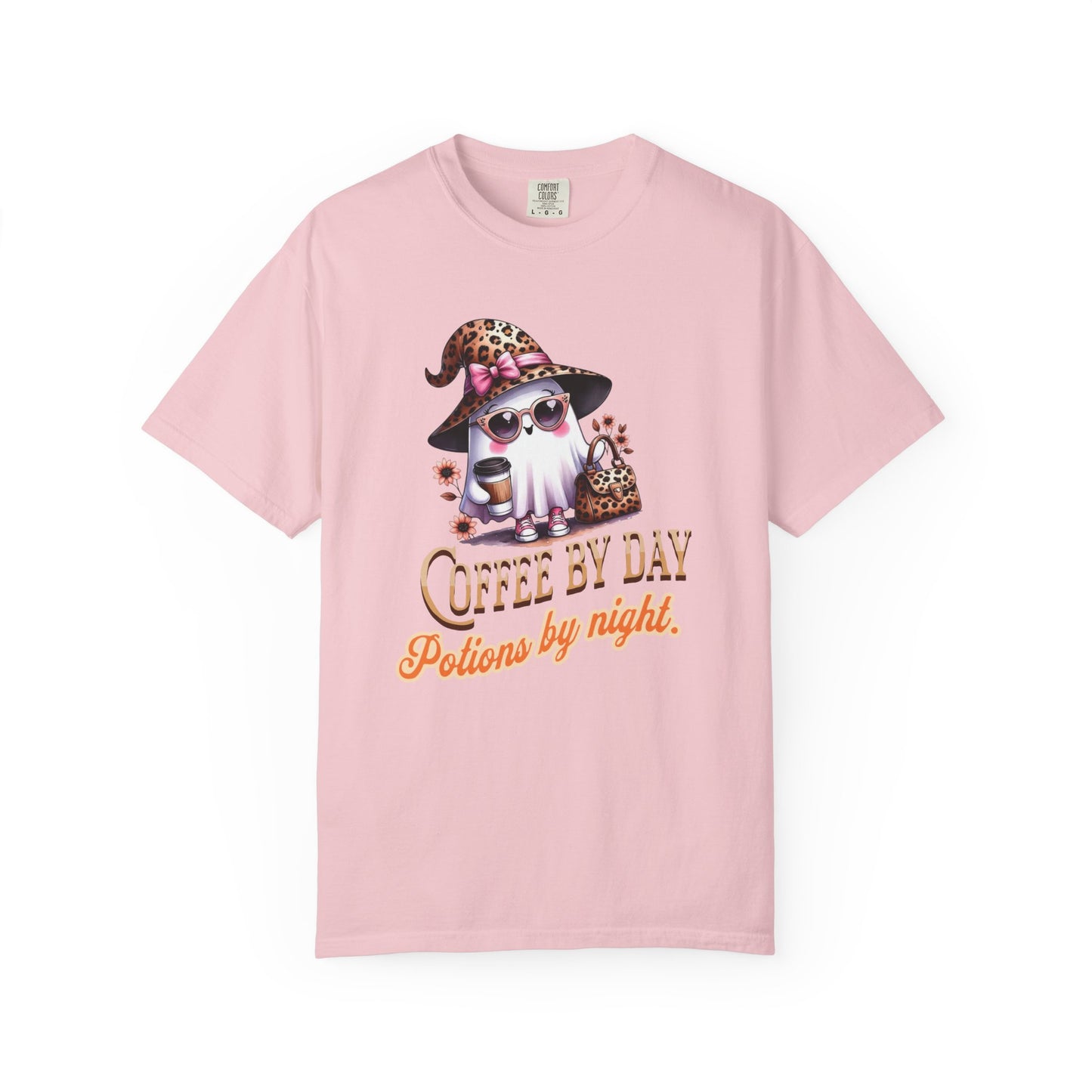 Pink t-shirt with a graphic of a gnome wearing sunglasses and a hat, with text 'Coffee by Day, Potions by Night' on a white background.
