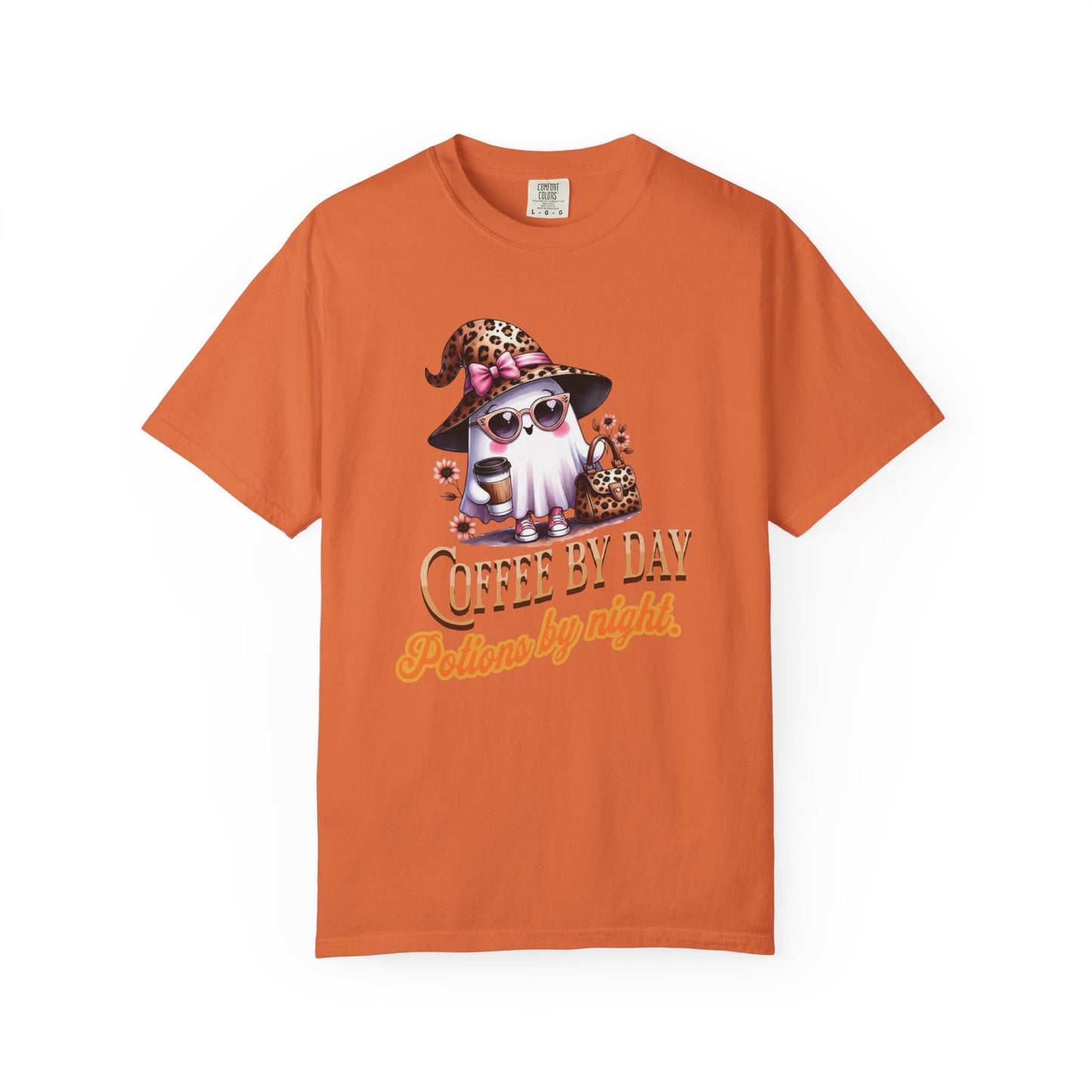 Orange t-shirt with a graphic of a cat in a witch hat and sunglasses, with text 'Coffee by Day, Potion by Night' on a white background.