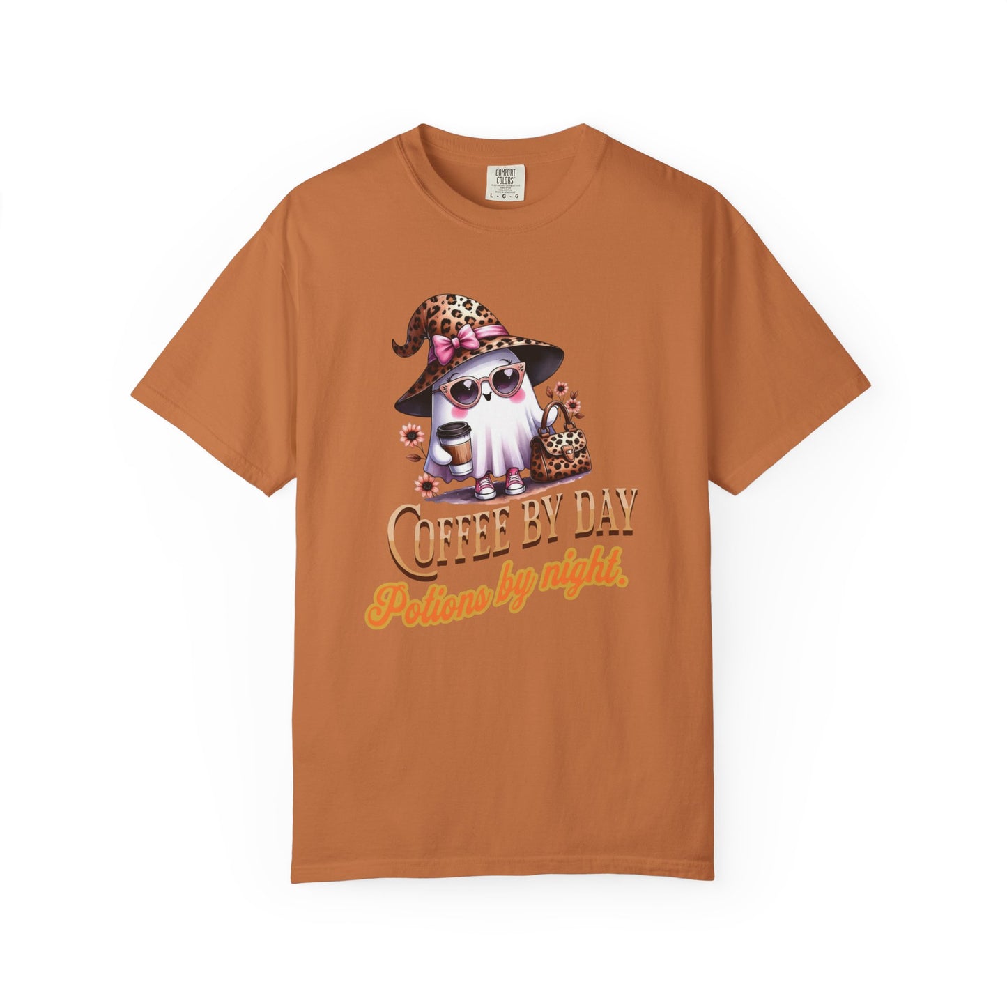 Brown t-shirt with a graphic of a cat in a witch hat and sunglasses, with text 'Coffee by Day, Potion by Night' on a white background.