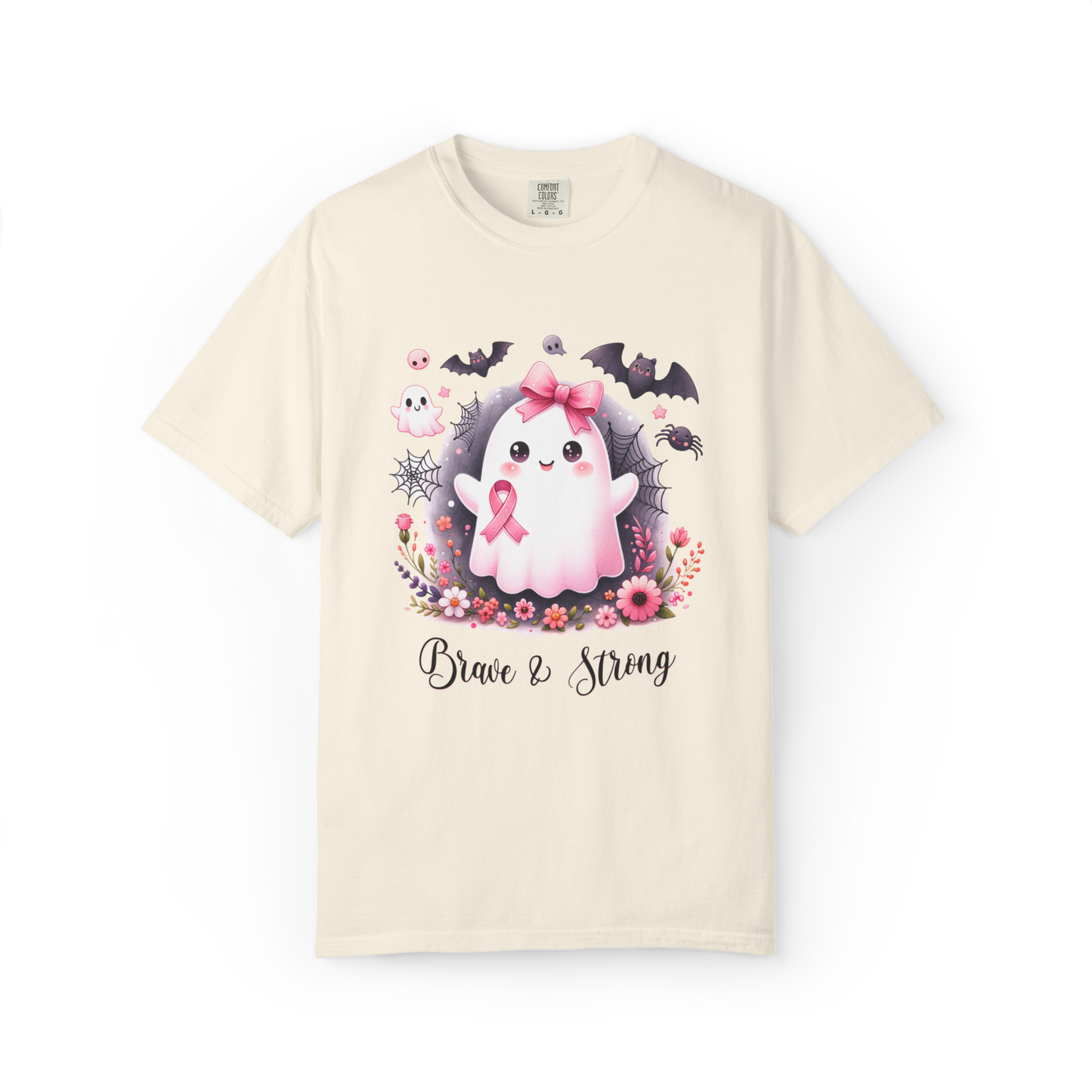 Beige t-shirt with a cartoon character holding a pink ribbon, surrounded by flowers and text 'Brave & Strong' on a white background.