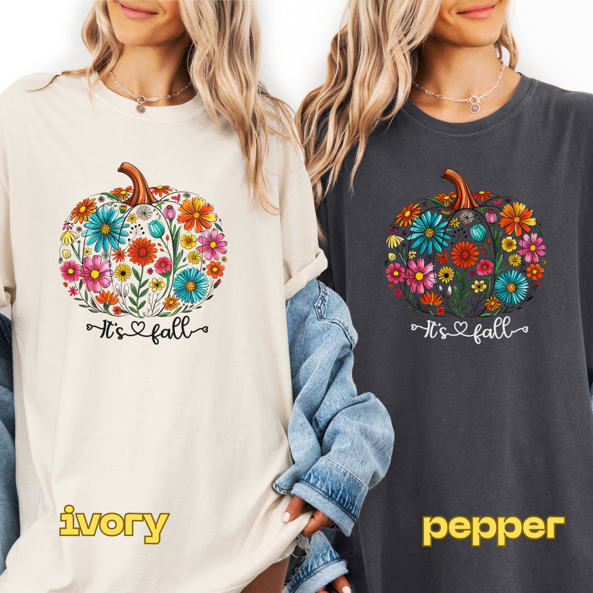 Two people wearing sweatshirts with a floral pumpkin design and 'It's fall' text, one in ivory and one in pepper color.