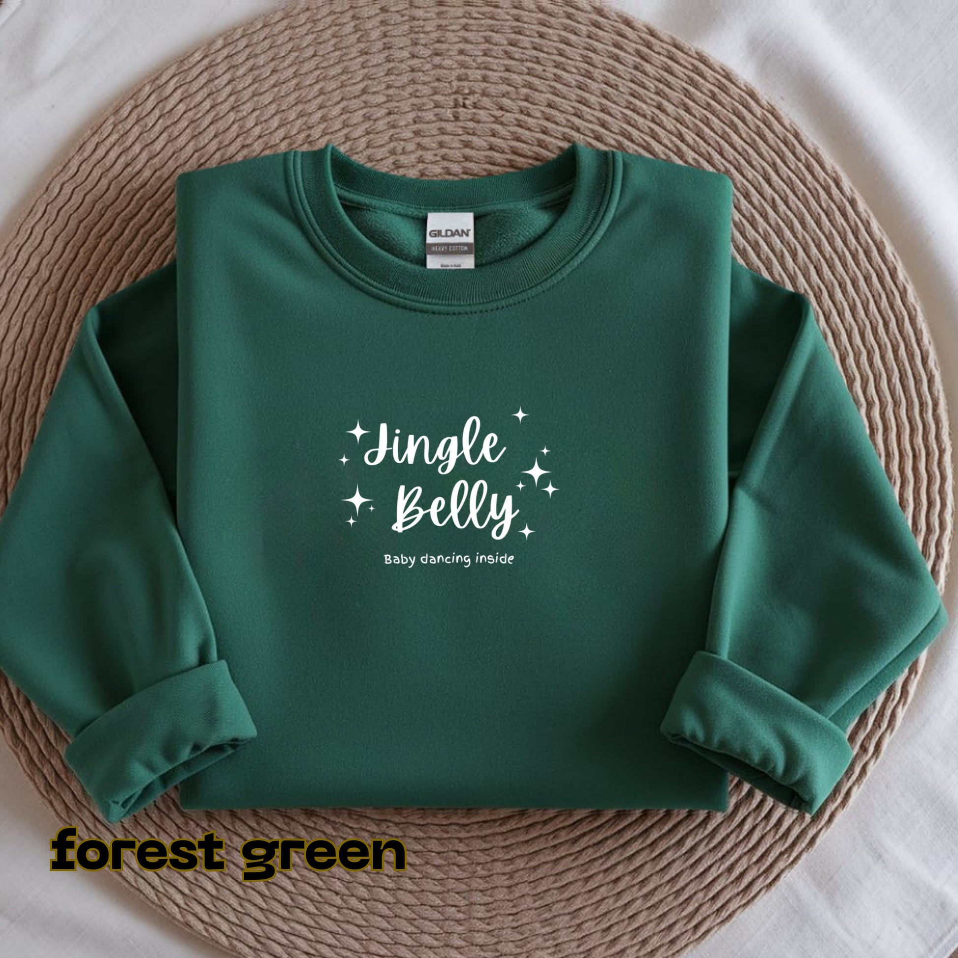 Green sweatshirt with 'Jingle Belly' text on a textured surface