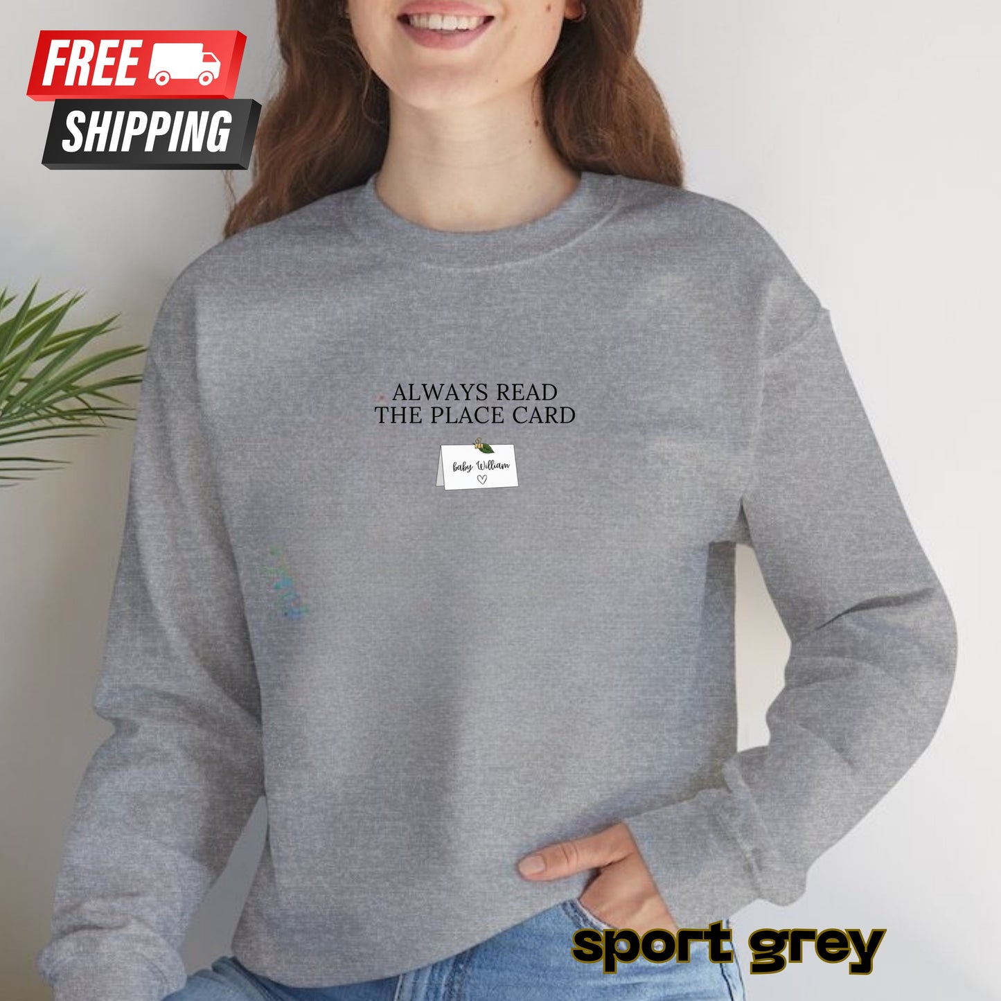 Person wearing a gray sweatshirt with text and free shipping label