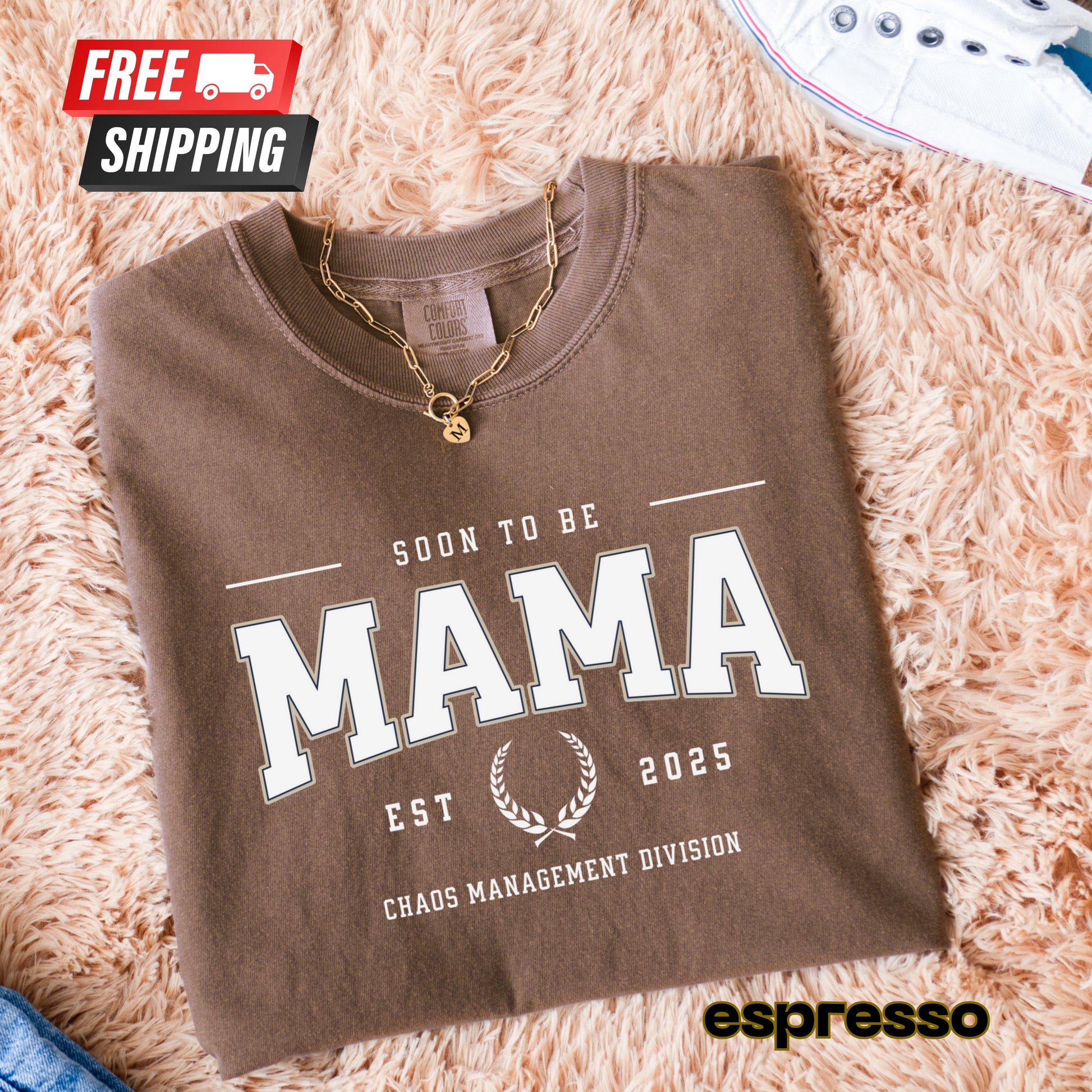 Folded brown sweatshirt with 'Soon to be Mama' text on a fluffy pink surface, featuring 'espresso' branding.