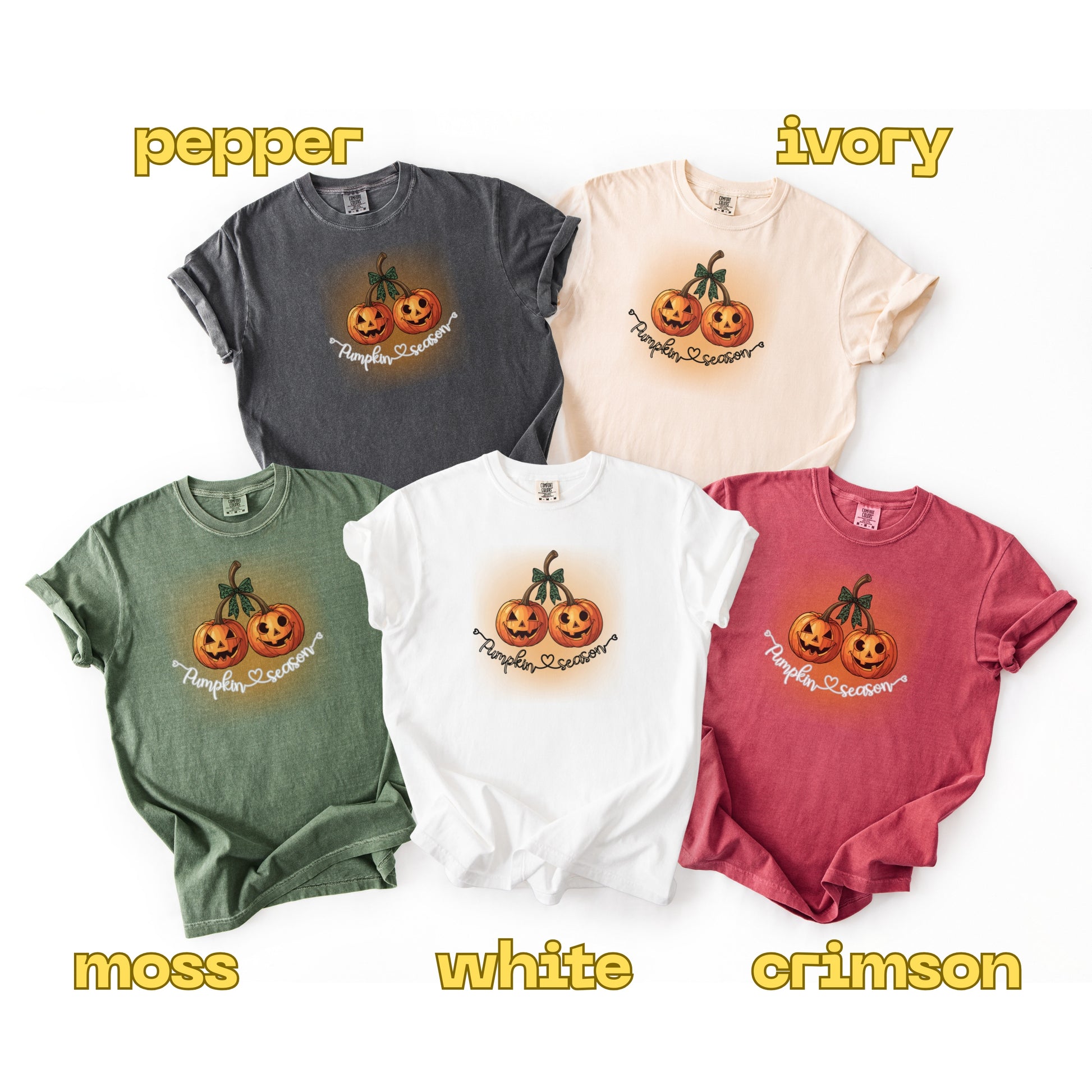 Five t-shirts in different colors with a pumpkin design on a white background