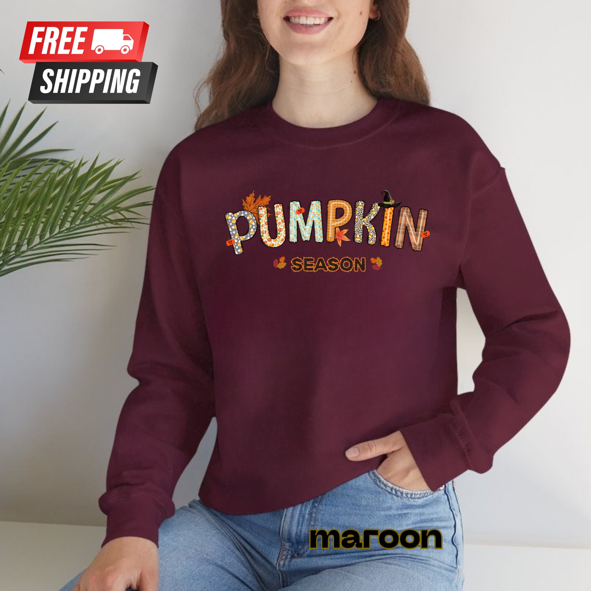 Person wearing a maroon sweatshirt with 'Pumpkin Season' text, sitting against a white background.