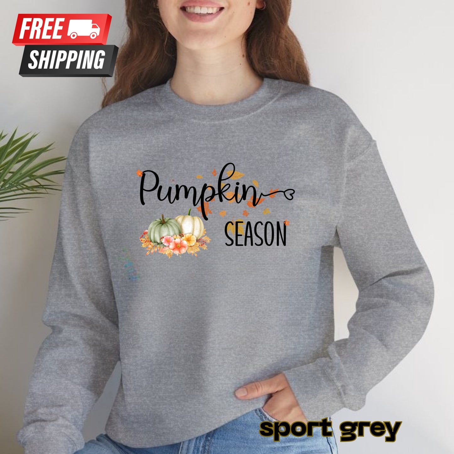 Person wearing a gray sweatshirt with 'Pumpkin Season' text and pumpkins design, on a plain background.