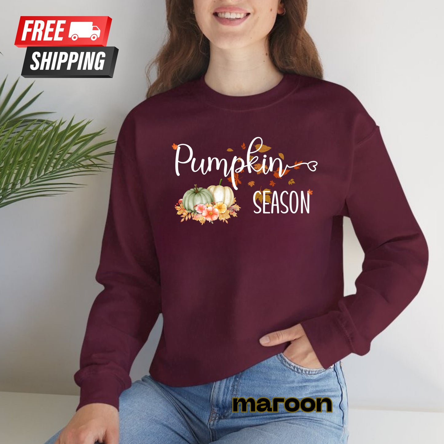 Person wearing a maroon sweatshirt with 'Pumpkin Season' text and graphics, sitting against a white background.