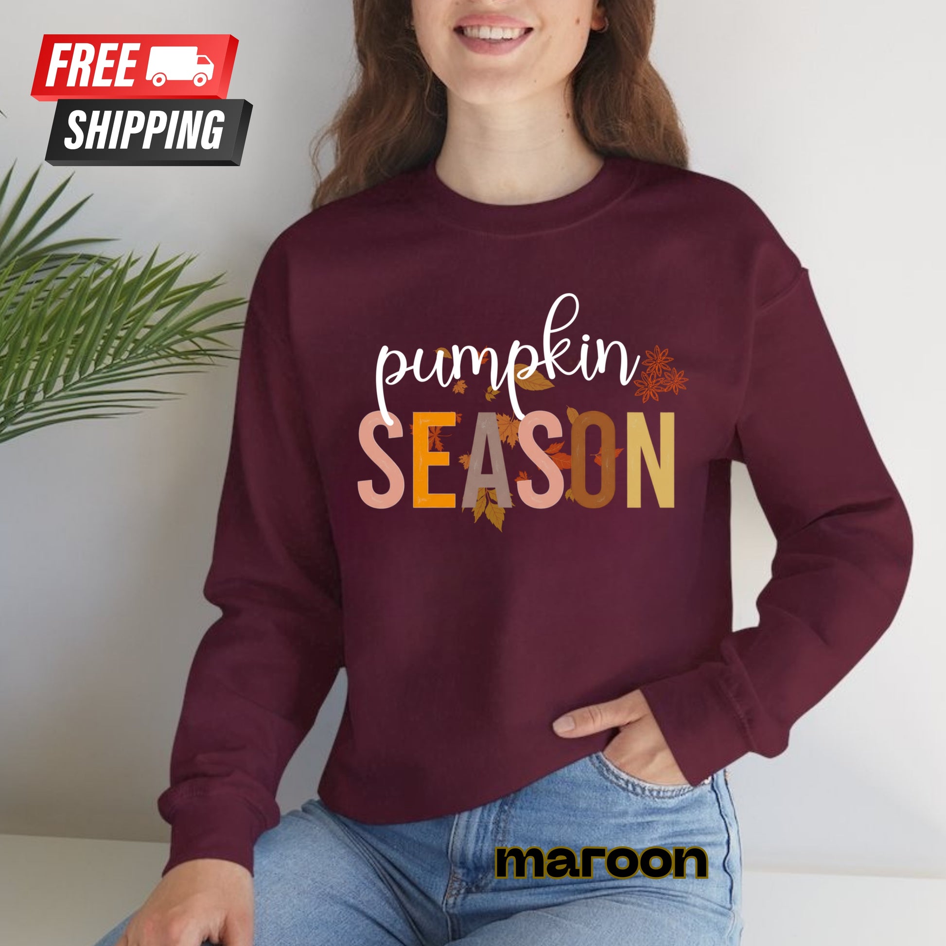 Person wearing a maroon sweatshirt with 'pumpkin SEASON' text, sitting indoors.