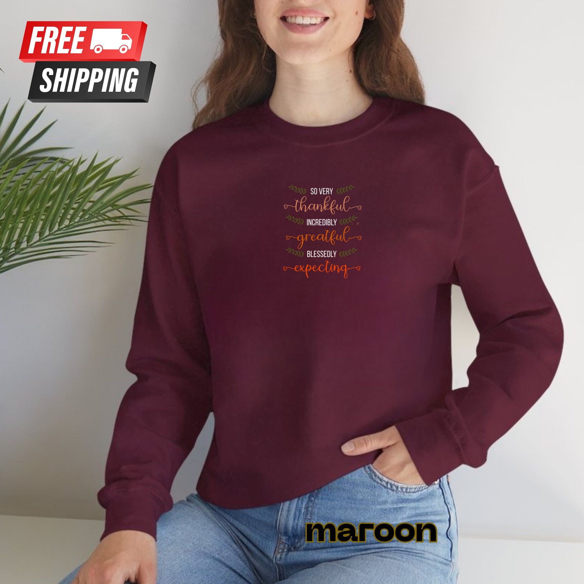 Person wearing a maroon sweatshirt with text, sitting against a white background with 'maroon' branding.
