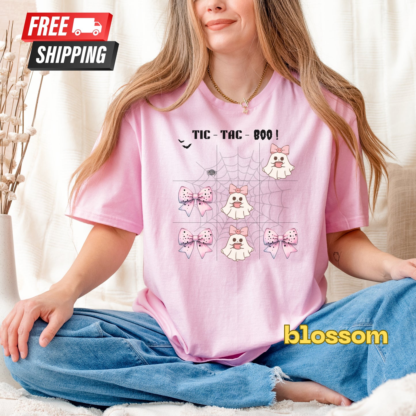 Person wearing a pink t-shirt with cartoon designs and text, sitting on a couch.