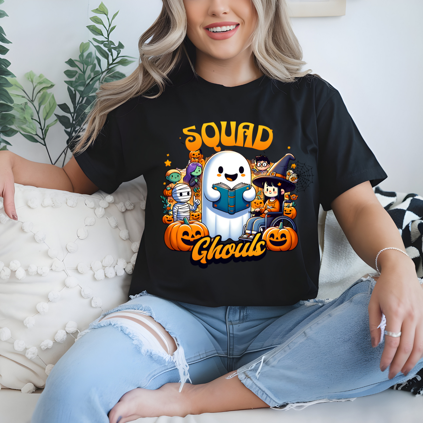 Person wearing a black t-shirt with Halloween-themed graphics and text.