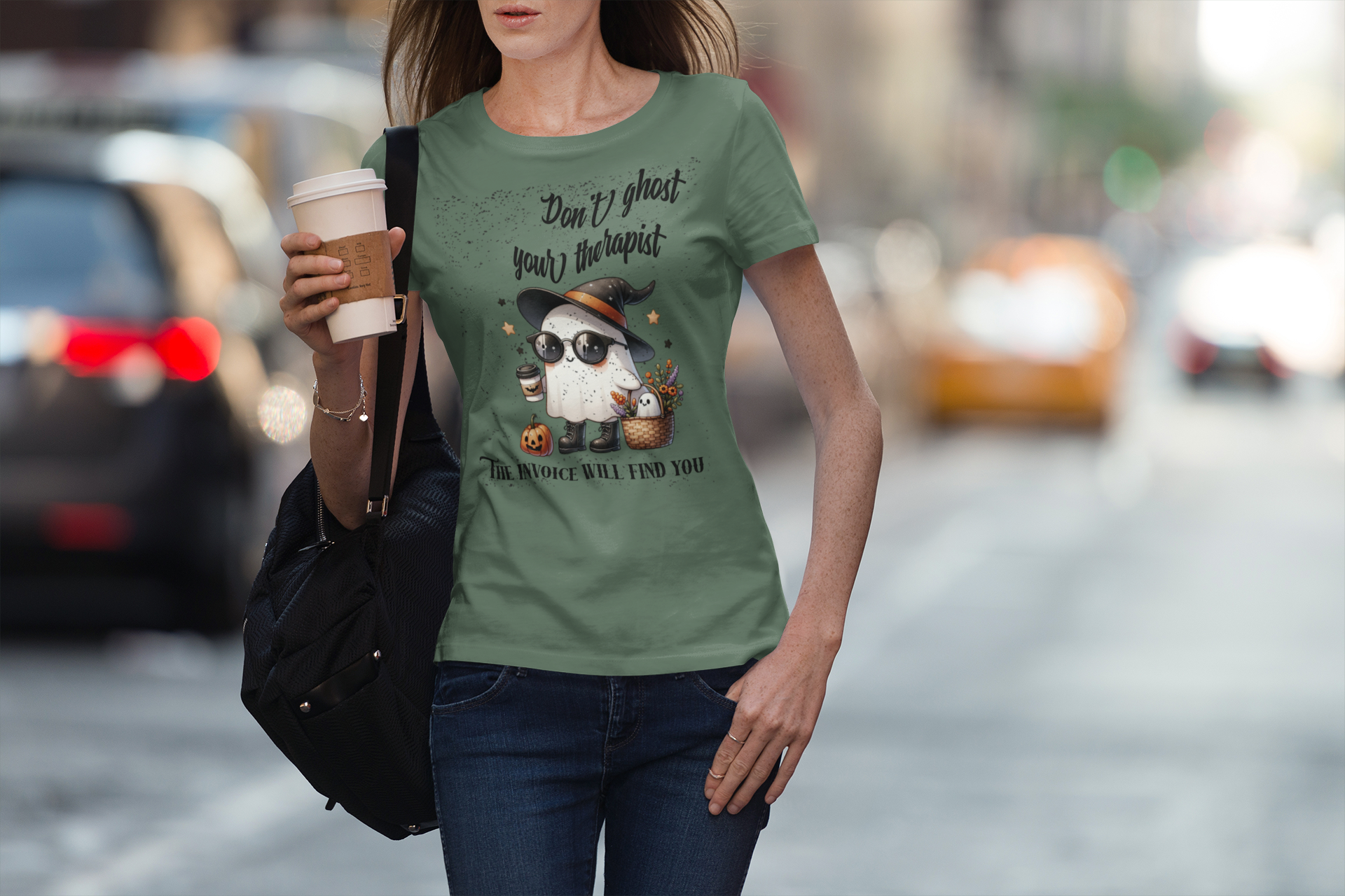 Woman wearing a green t-shirt with a pug graphic and text, holding a coffee cup on a city street.