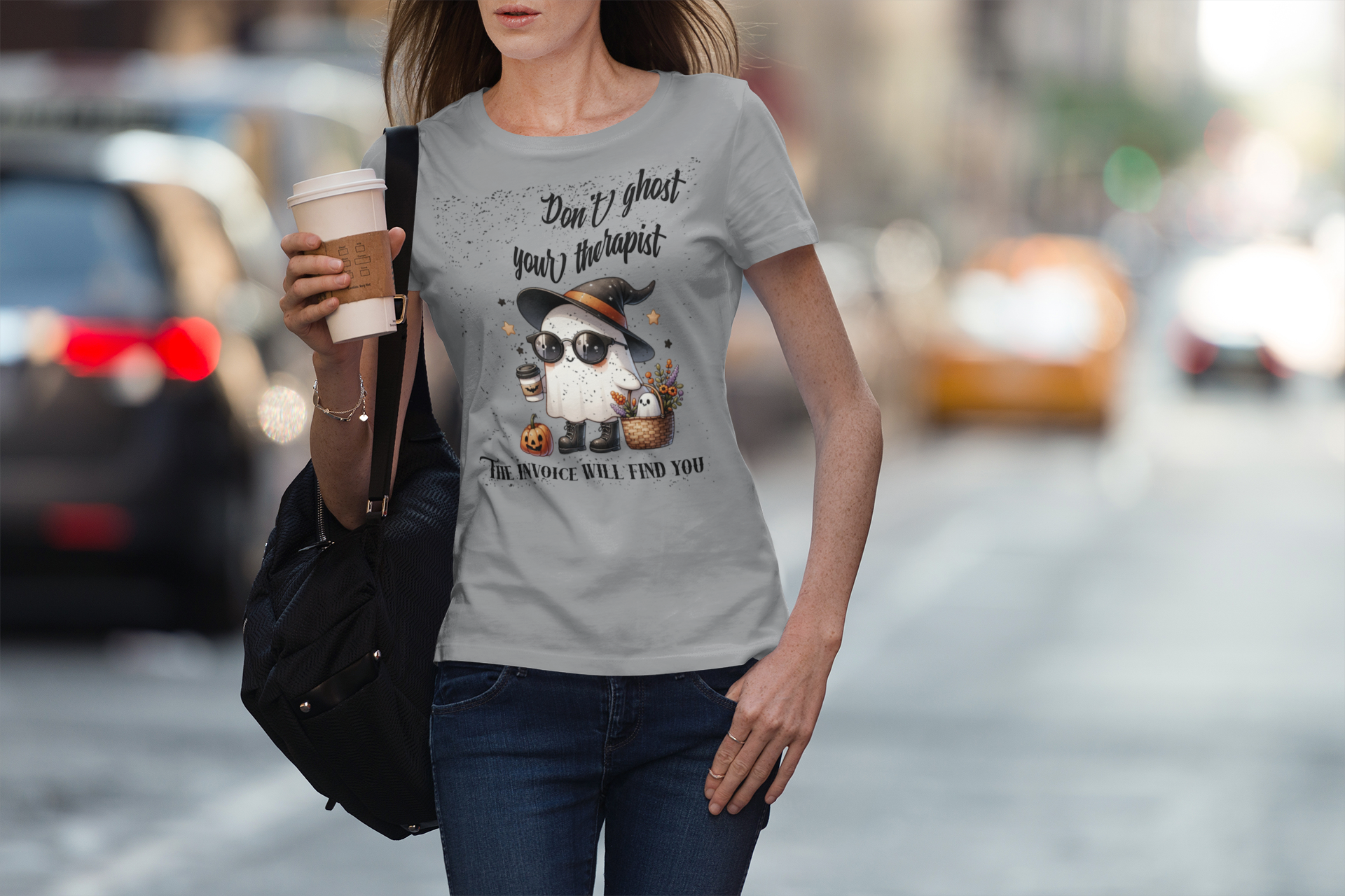 Woman wearing a t-shirt with a graphic design on a city street.