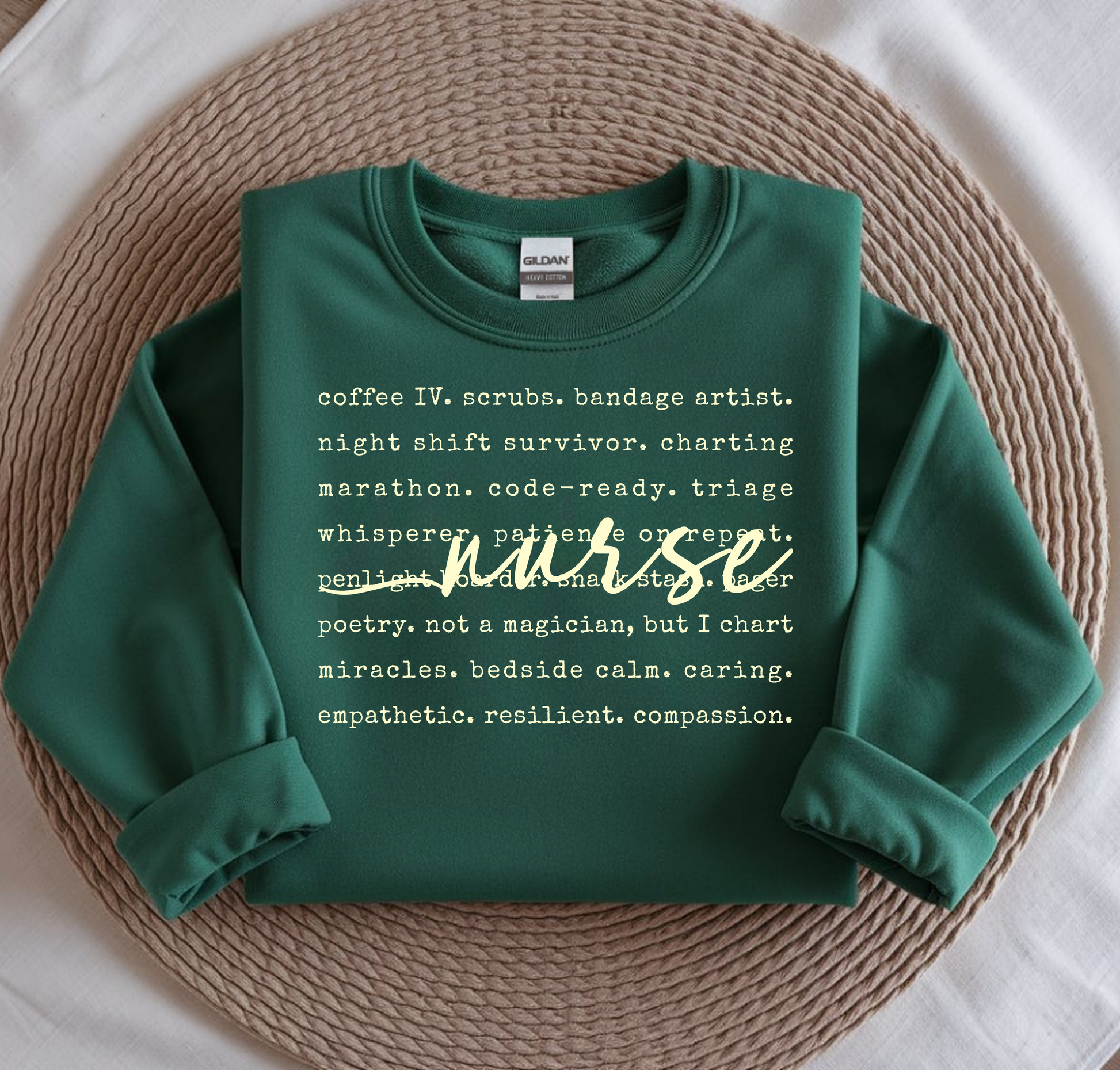 Green sweatshirt with text on a woven mat