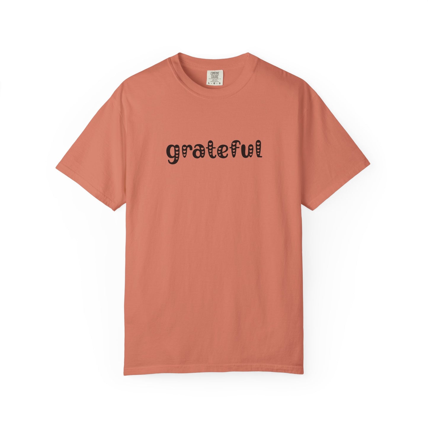 Coral t-shirt with 'grateful' text on a white background