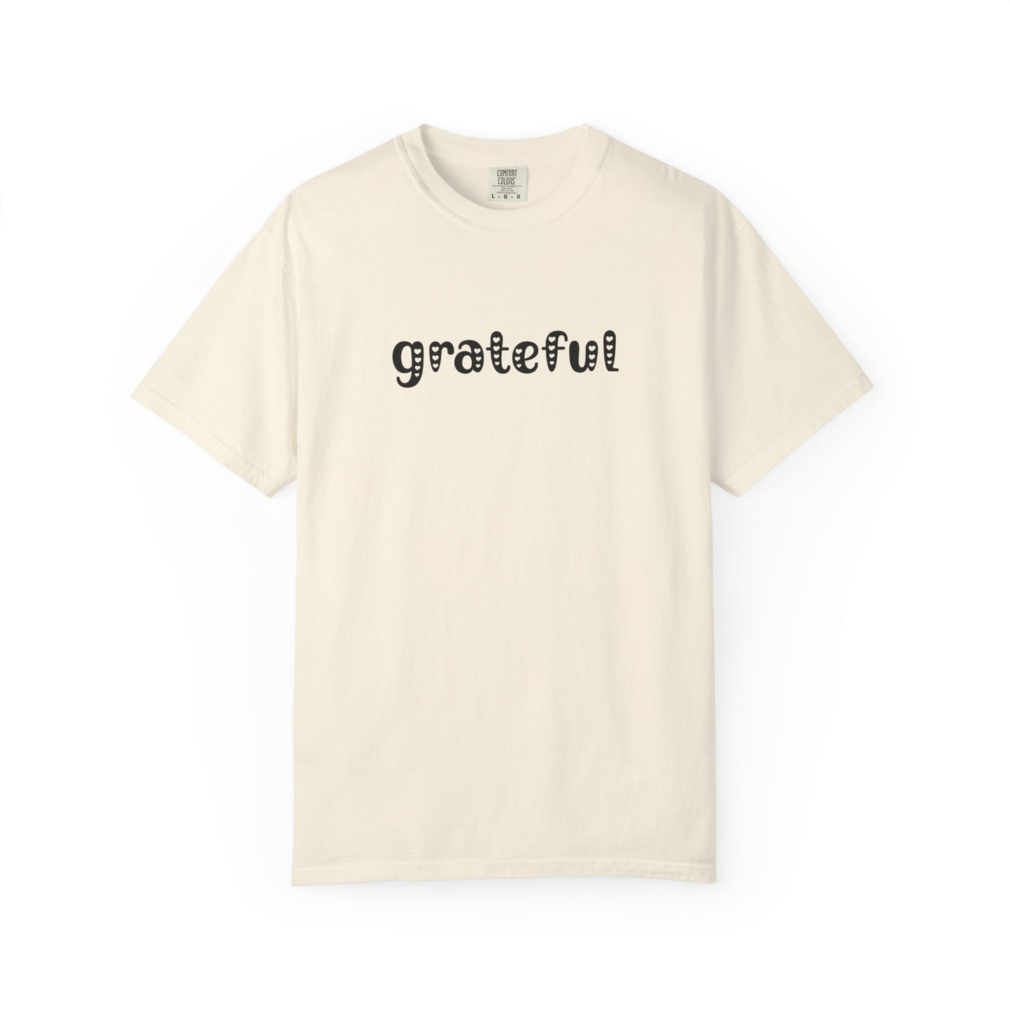 Beige t-shirt with 'grateful' text on a white background