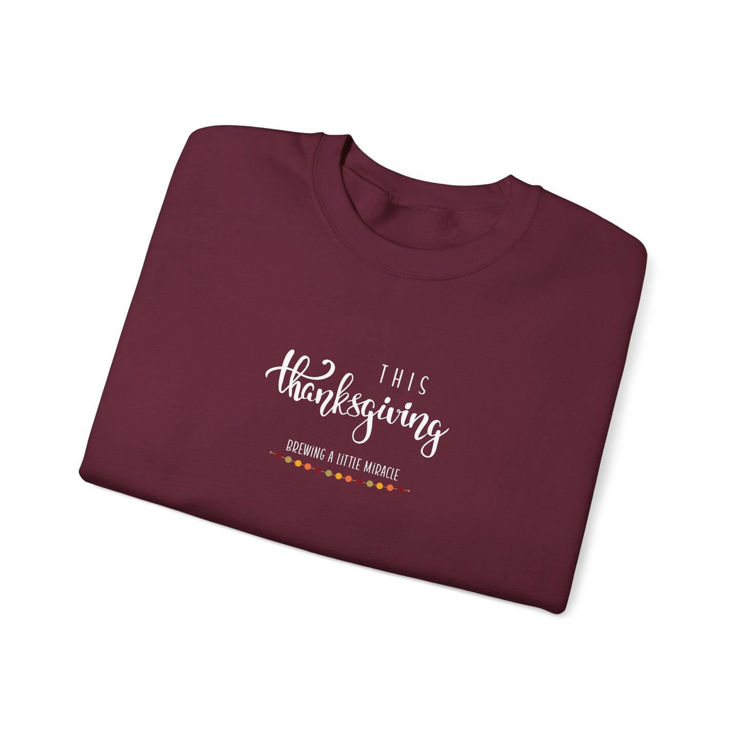 Folded maroon sweatshirt with 'This Thanksgiving' text on a white background