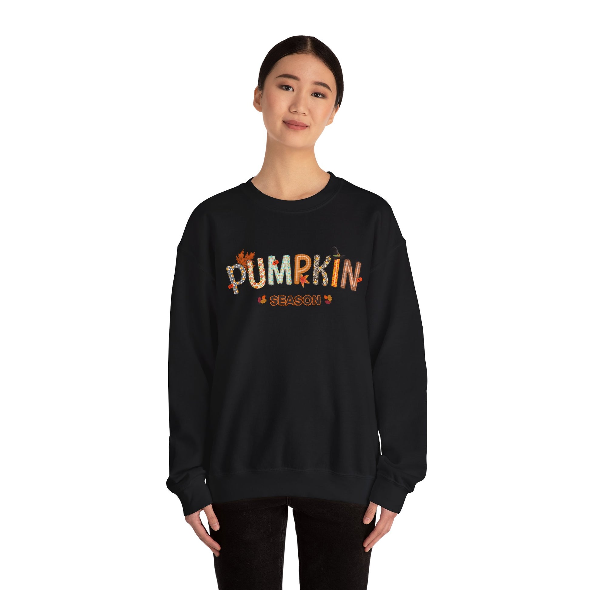 Person wearing a black sweatshirt with 'PUMPKIN SEASON' text on a white background